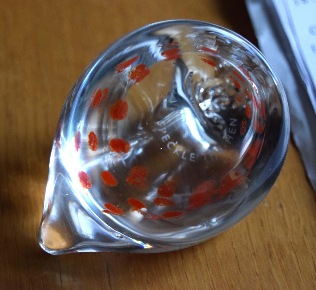 Delightful "Speckle the Hen" paperweight. Produced by the renowned Caithness Glass as part of their highly collectible "Zoo" series, this miniature figurine is a beautiful example of hand-blown craftsmanship.

The figurine features a stylized clear glass chicken body beautifully embedded with vibrant orange and red speckled mottling. Perfect for animal lovers, paperweight collectors, or country kitchen accent decor.
