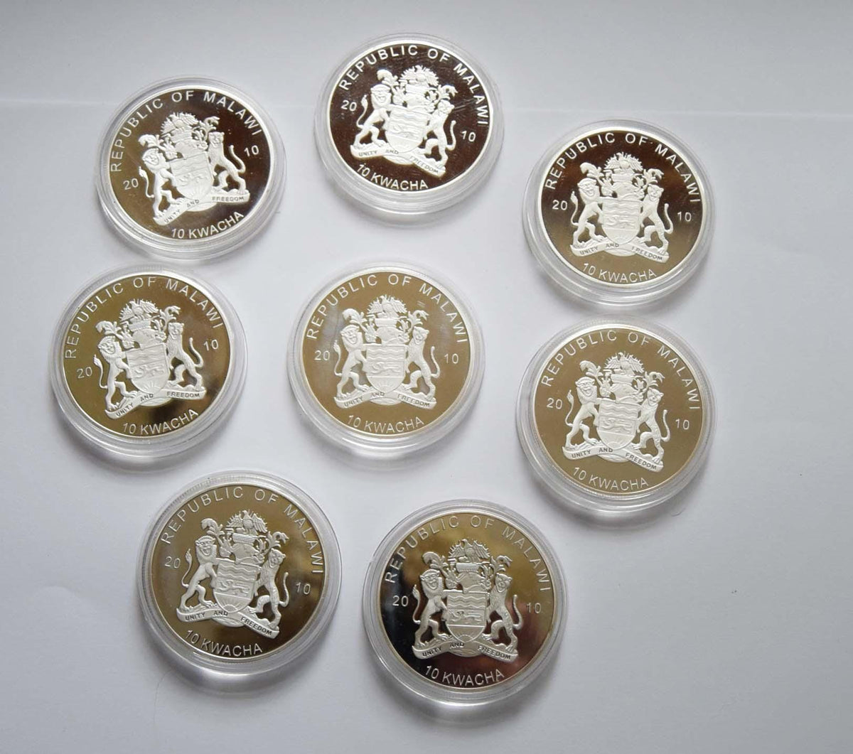 Beautiful set of eight (8) legal tender commemorative coins from the highly collectible 2010 Malawi "Birds of Prey" series. Every coin features an intricately detailed, vibrant colorized center showcasing a specific raptor, framed by a brilliant proof silver-plated finish.

